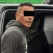 Man in a gray hoodie getting into a dark van or SUV; eyes are covered with a black bar for anonymity.